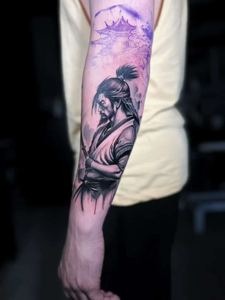 Tatuaje realista de samurái con paisaje japonés en el antebrazo